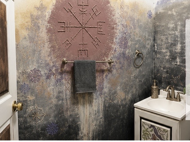 Finished raised wall art bathroom accent wall with mauve compass symbol and layered weathered background